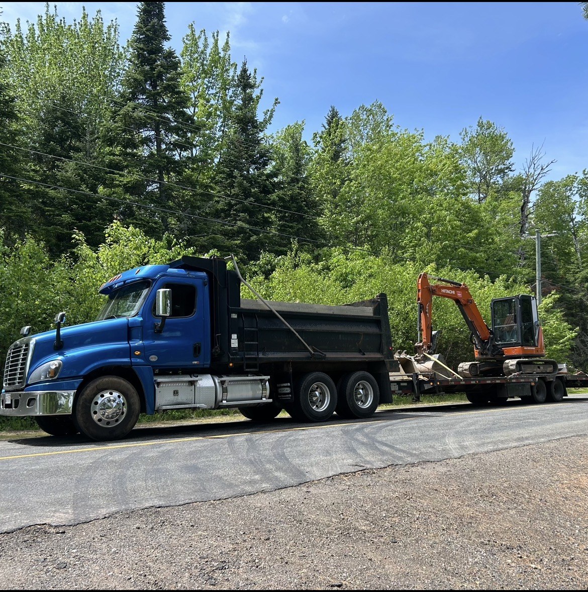 Dump truck and Hitachi excavator